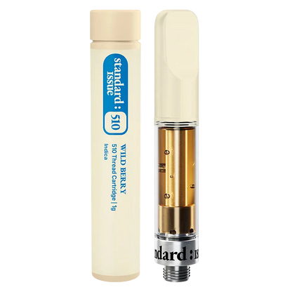 Close-up front view of the Wild Berry Vape Cartridge showing a clear glass cartridge with gold interior components beside its cream-colored 1 g tube.