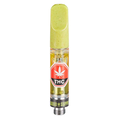 Straight-on studio view of the Berry Blurry Vape Cartridge showing a green mouthpiece, clear cartridge body with golden oil and a red THC label.