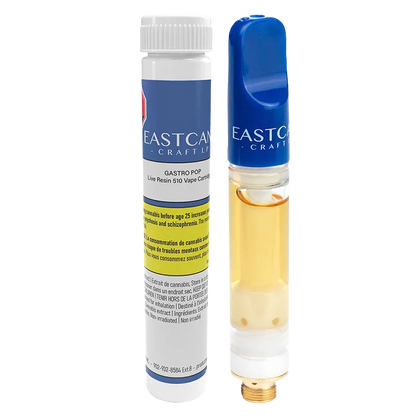 Studio-lit close-up of the Gastro Pop Live Resin Vape Cartridge standing upright beside its labeled white and blue cylinder packaging.