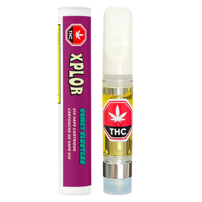 Straight-on product shot of a Comet Clusters Vape Cartridge showing the clear 510 cartridge of amber oil with a white mouthpiece next to its purple cylindrical packaging.