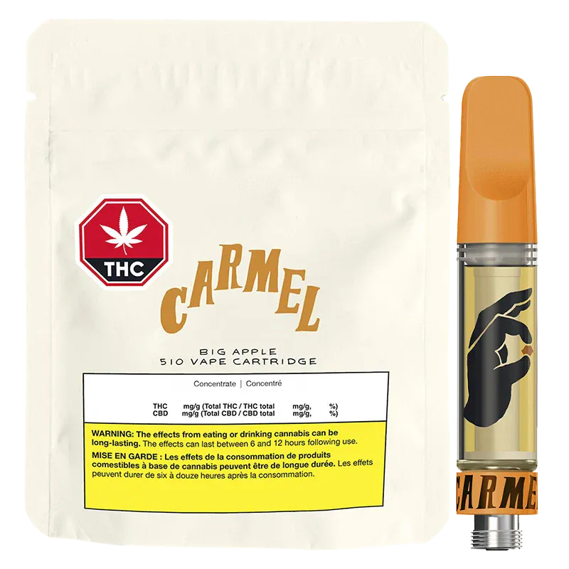 Front-facing shot of the Big Apple Pure Live Resin Vape Cartridge showing its orange-topped cartridge with a black hand logo beside a cream resealable pouch labeled "Carmel."