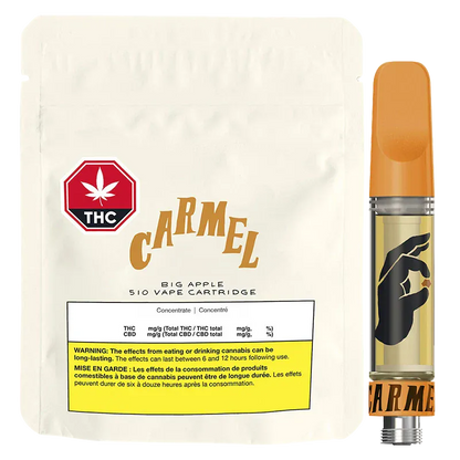 Front-facing shot of the Big Apple Pure Live Resin Vape Cartridge showing its orange-topped cartridge with a black hand logo beside a cream resealable pouch labeled "Carmel."