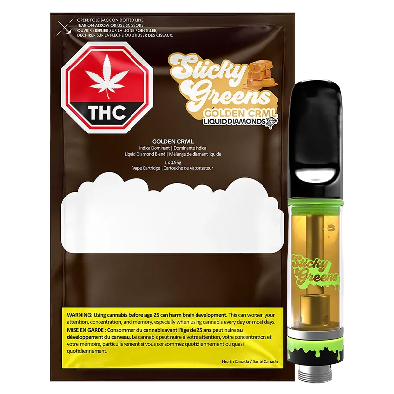 Right-side close-up of the Golden CRML Liquid Diamond Vape Cartridge standing upright beside its Sticky Greens packaging, showing the amber cartridge liquid, black mouthpiece, and green-accented base.