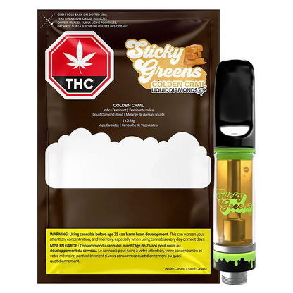 Right-side close-up of the Golden CRML Liquid Diamond Vape Cartridge standing upright beside its Sticky Greens packaging, showing the amber cartridge liquid, black mouthpiece, and green-accented base.