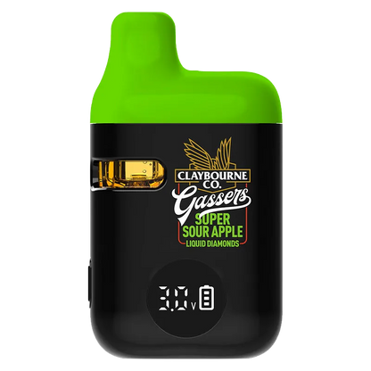 Front-facing close-up of the Gassers Super Sour Apple Liquid Diamonds Disposable Vape showing its black body, bright green mouthpiece, visible amber liquid window, and digital voltage display.