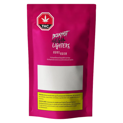 Front-facing shot of a magenta pouch labeled "Ruby Rush Liquid Diamond Charged Disposable Vape" with THC icon and blank white label.
