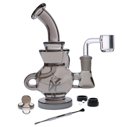 Angled side view of the Dab Freak - Squall Dab Rig 6.7 in in smoky glass with a bent mouthpiece, banger, and accessories.