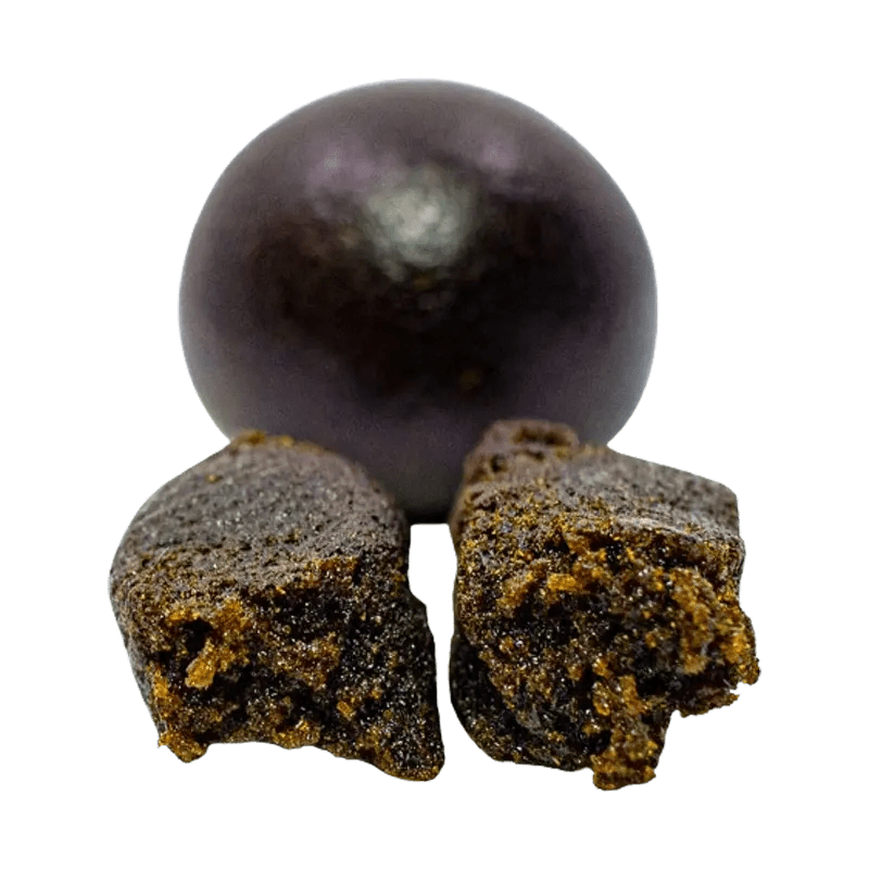 A close-up, angled view of the dark brown Afghan Black Pressed Hash, showing its roughly textured, pressed form.