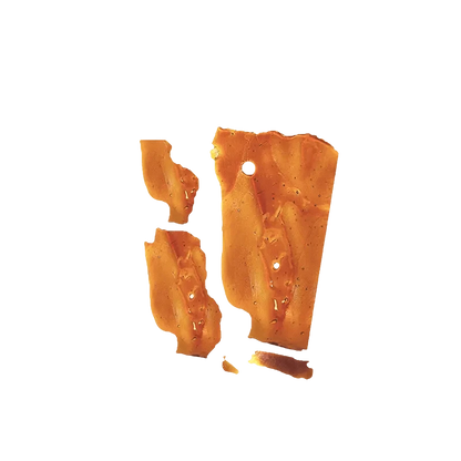 A close-up view of Pink Kush Shatter, showcasing its translucent amber color and fractured, glassy texture.