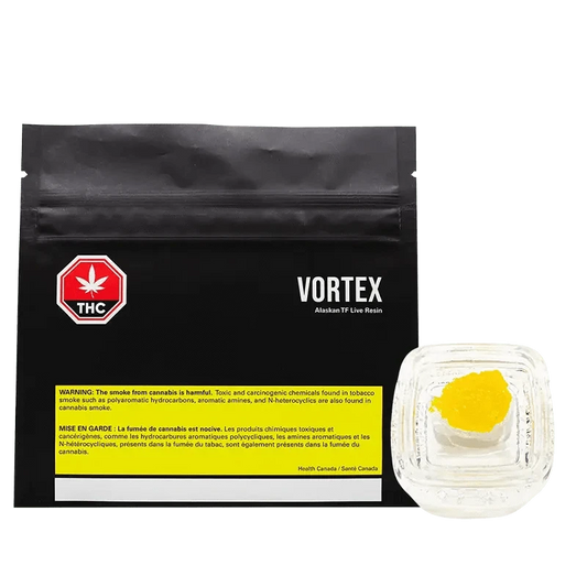 Close-up of the Alaskan TF Live Resin packaging, featuring a vortex design and warning text on a dark background.