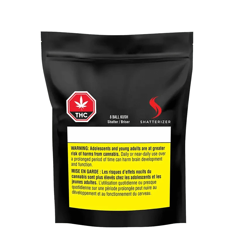 Close-up of the 8 Ball Kush Shatter packaging with a warning sign and bold text on a dark background.
