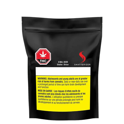 Close-up of the 8 Ball Kush Shatter packaging with a warning sign and bold text on a dark background.