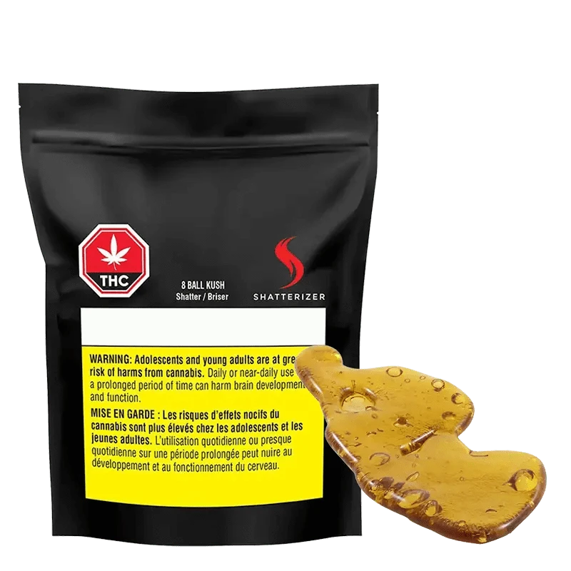 Close-up of the 8 Ball Kush Shatter against a black background, showcasing its branding and textured surface.