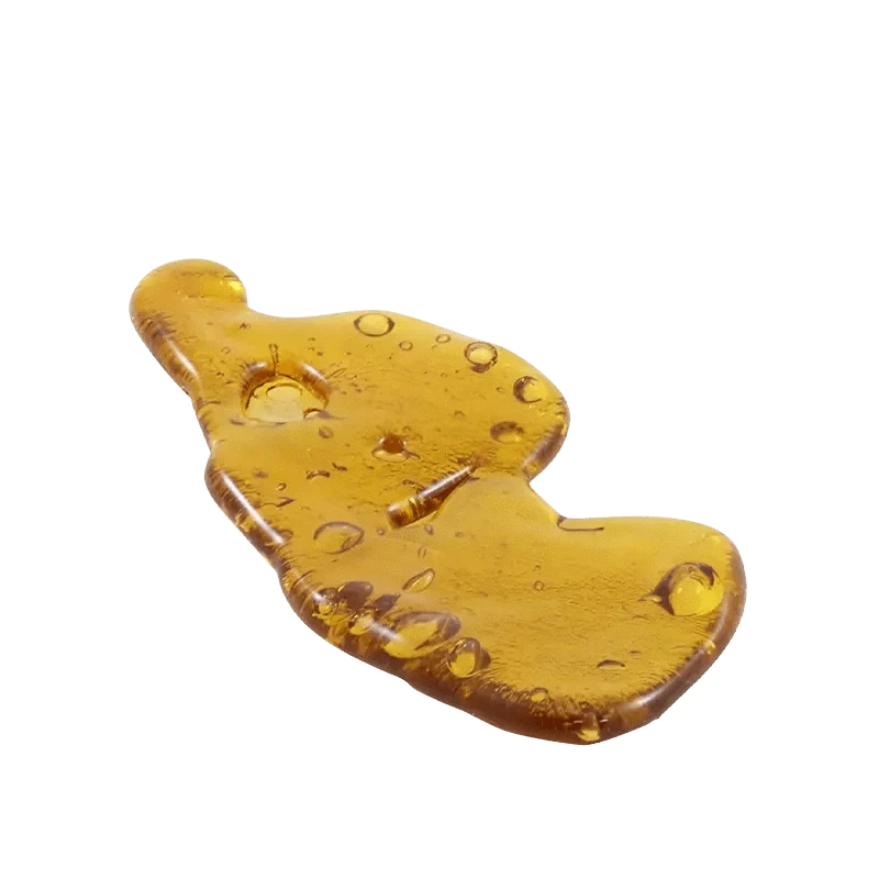 A close-up shot of the amber-colored 8 Ball Kush Shatter, displaying its translucent, glassy texture.