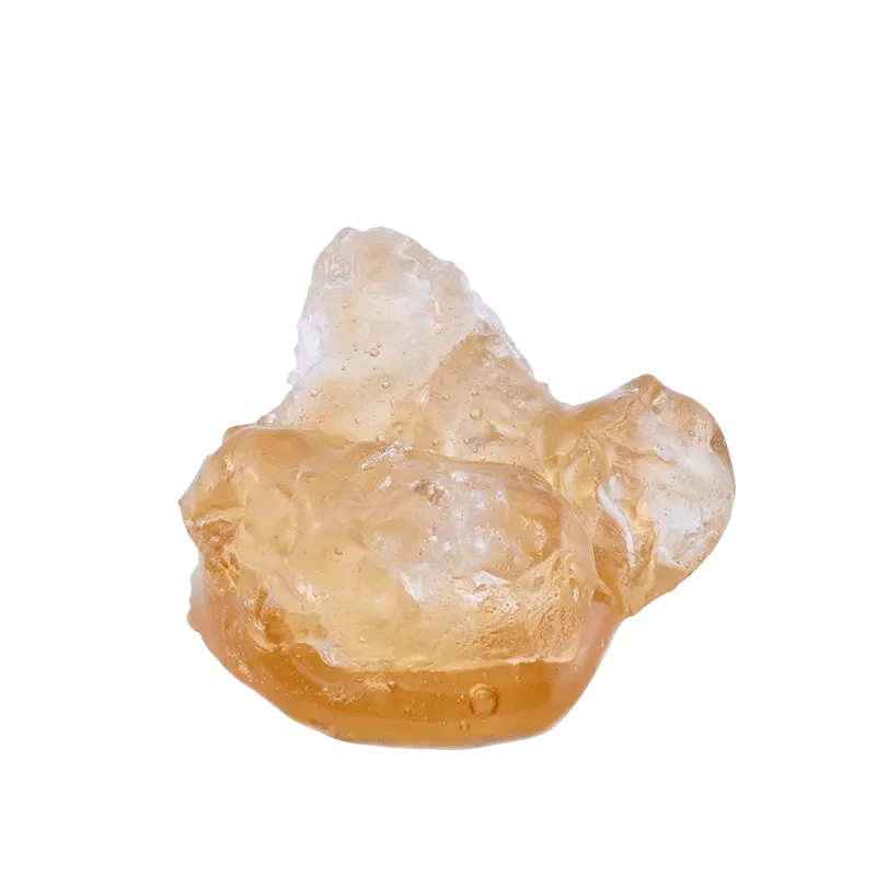 A close-up view of Garlic Sauce on the Rocks Diamonds and Terp Sauce with a translucent, rocky texture, illuminated against a bright background.