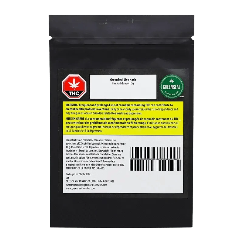 Close-up of GreenSeal Live Hash packaging with a warning label in French, showing a blurred golden product inside.