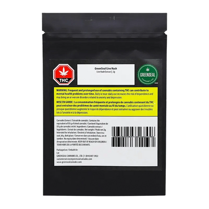 Close-up of GreenSeal Live Hash packaging with a warning label in French, showing a blurred golden product inside.