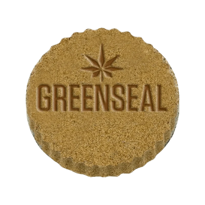 Close-up of Live Hash, displaying its textured surface and warm tones against a stark white background.