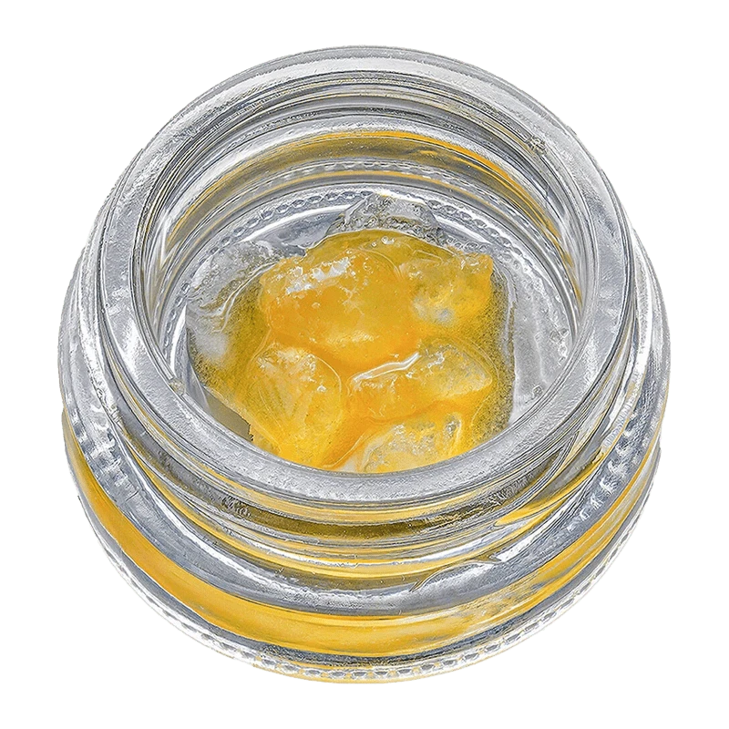 Overhead view of Fruit Sauce on the Rocks, a golden, viscous substance filling a clear glass container.