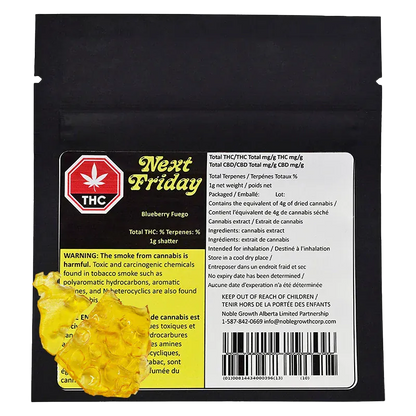 Flat front view of the Next Friday Blueberry Fuego Shatter 1 g black resealable pouch with a yellow warning panel and two pieces of amber shatter at the lower left.
