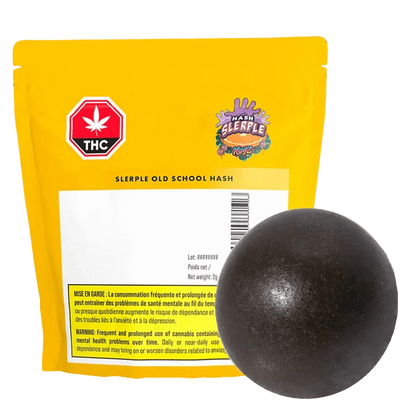 A close-up of the Slerple Old School Hash, a dark, rectangular block with visible branding and French text on the packaging.