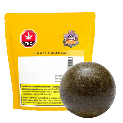 A close-up of the G Sherb Old School Traditional Hash, displaying a beige block with black lettering against a dark backdrop.