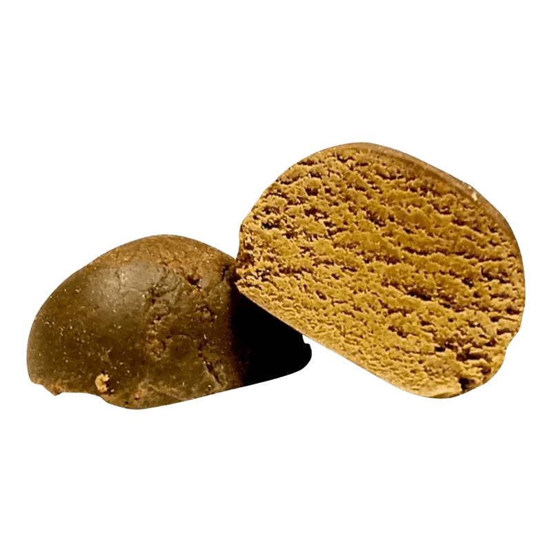Close-up view of the dark brown O.G. Hash, displaying its textured, rounded shape against a plain white background.