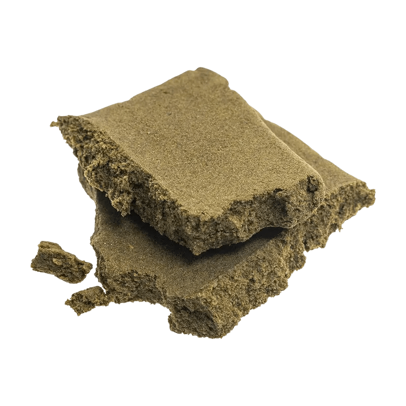 A close-up, top-down view of the Sungrown Traditional Hash, a dark, textured block with visible layers and irregular edges.