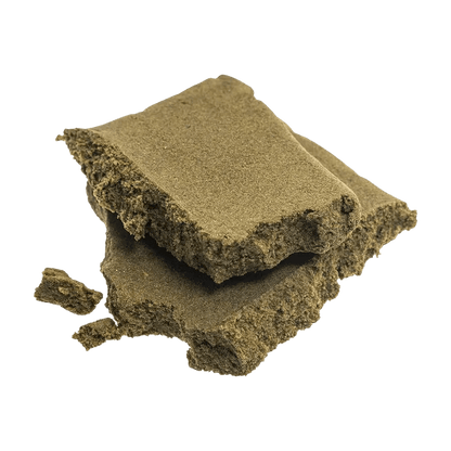 A close-up, top-down view of the Sungrown Traditional Hash, a dark, textured block with visible layers and irregular edges.