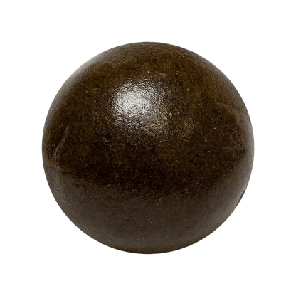 A close-up, top-down view of the Slapz Ice Water Hash, a dark, circular substance resembling a pressed pellet.