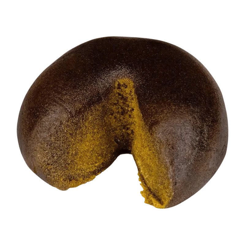 Close-up of the Haschtag STRWBRRY, a dark, rounded piece with a textured surface and a visible indentation.