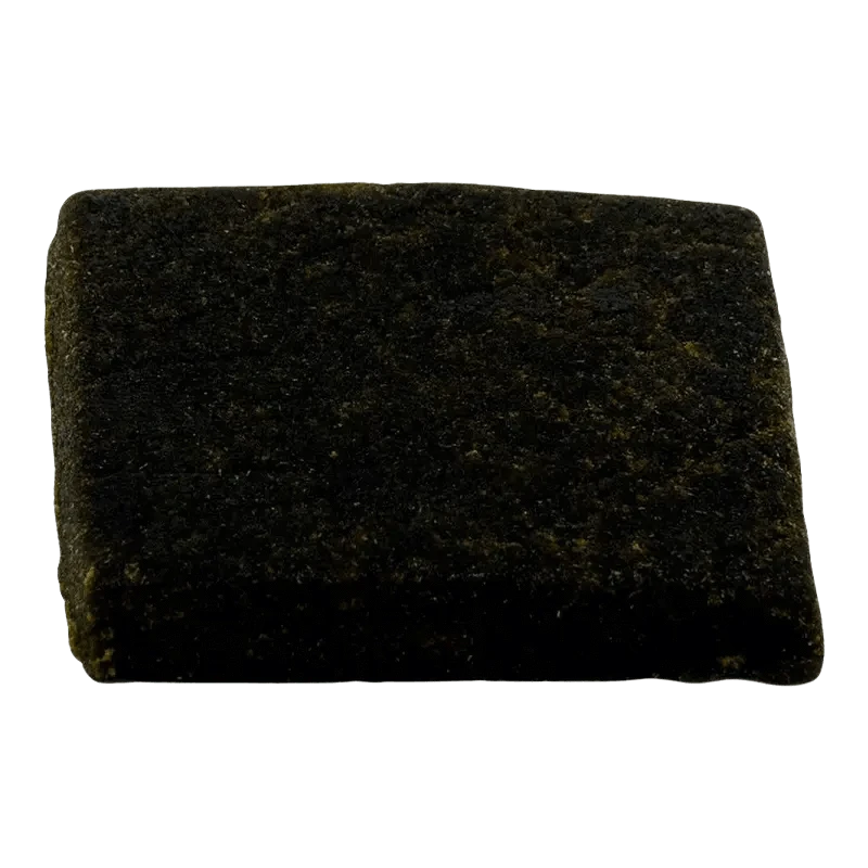 Close-up, top-down view of the Smokehouse Hash, showing a dark, textured material against a plain white background.
