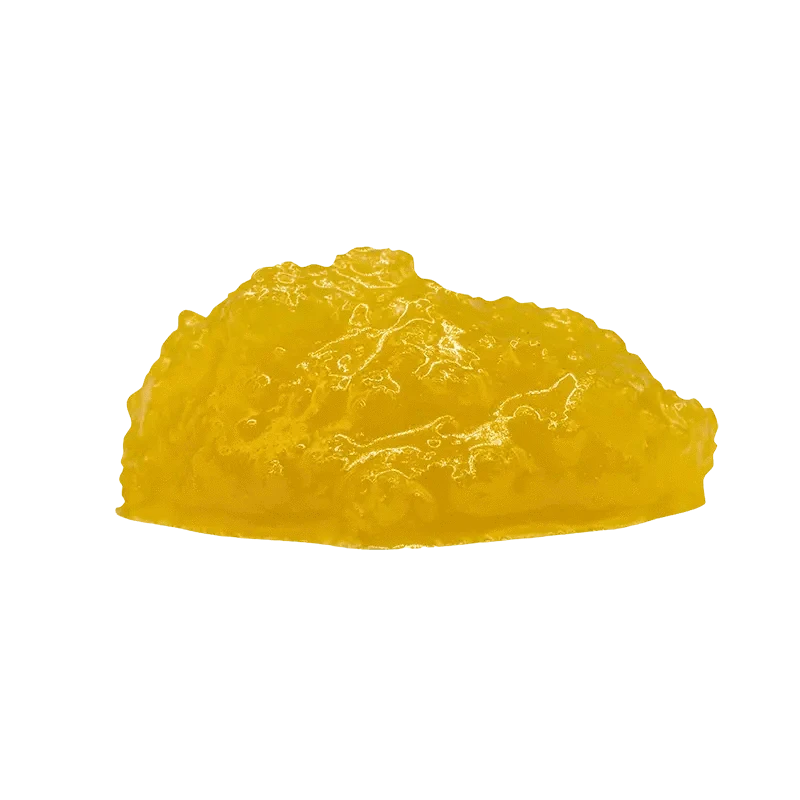 A close-up view of the golden, textured Indica Cured Resin, softly lit against a plain white background.