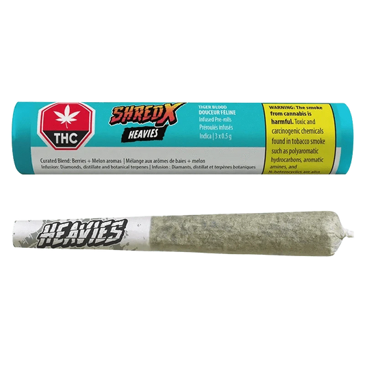 Close-up of the Tiger Blood Heavies Infused Pre Rolled 3 x 0.5 g package against a dark background, featuring bold branding and warnings.