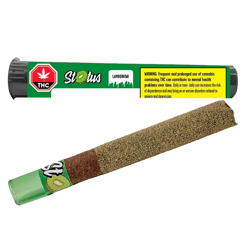 Angled close-up of a kiwi-coated pre-roll beside its green tube packaging labeled Lamborkiwi Liquid Diamond Infused PR 1 x 1 g.
