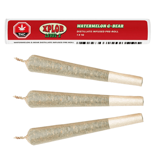 A close-up shot of the Watermelon G-Bear Distillate Infused Pre Rolled 1 x 1 g with a white label, displayed against a dark background.