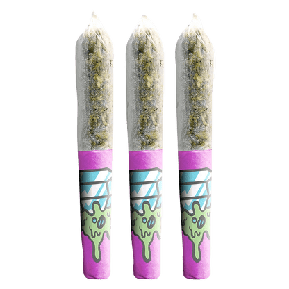 A slightly angled close-up of three Pearadise Dream Diamond Infused Pre Rolled 0.45g joints with vibrant green and purple detailing.