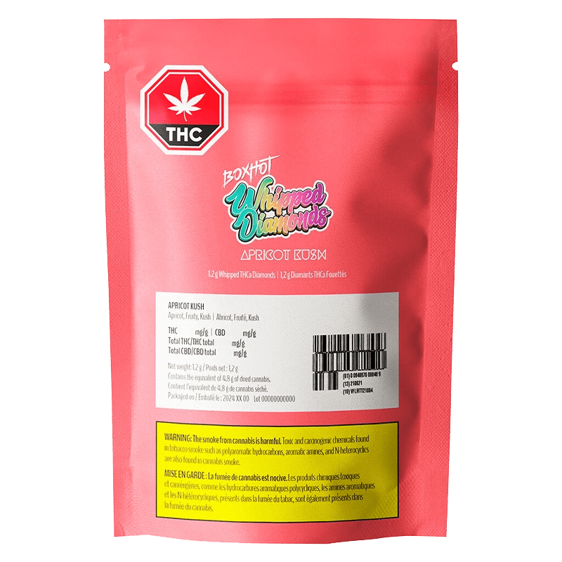 Close-up of Apricot Kush Diamonds packaging with bold lettering and THC/CBD information on a dark background.