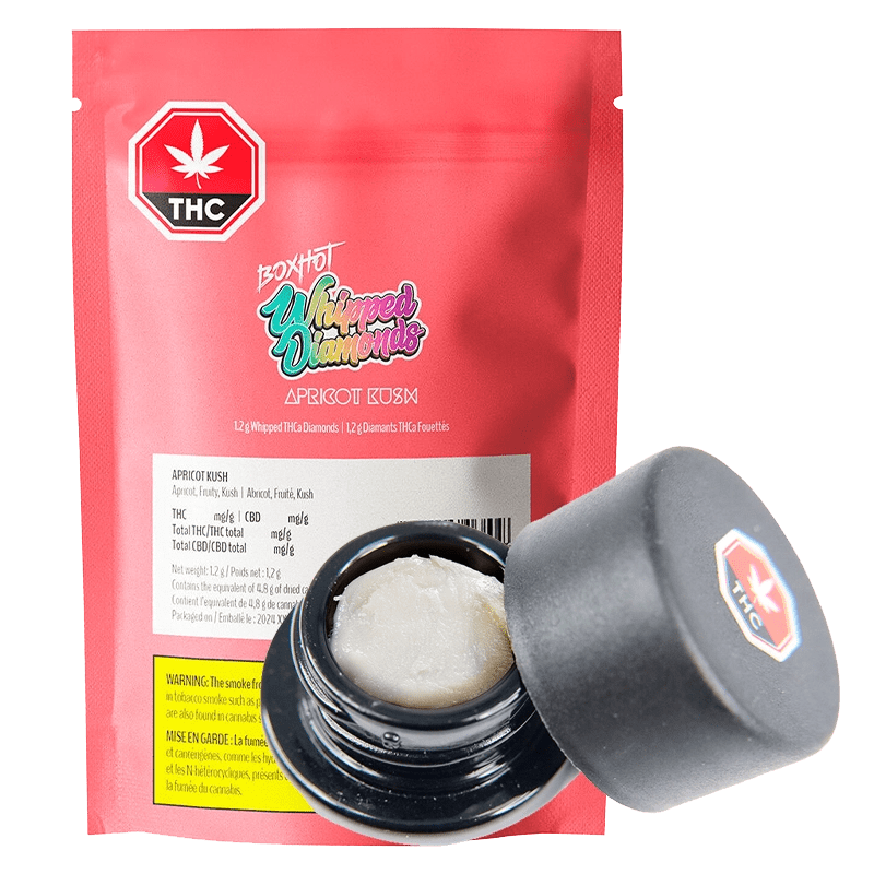 Close-up of Apricot Kush Diamonds, showing a branded package with the product name prominently displayed in a modern design.