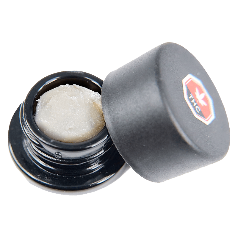 Close-up overhead view of Apricot Kush Diamonds, showing crystalline structures inside a dark container.