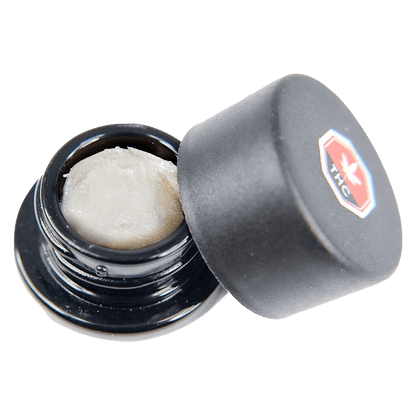 Close-up overhead view of Apricot Kush Diamonds, showing crystalline structures inside a dark container.