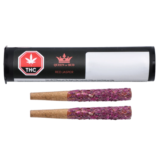 Horizontal product shot of Red Jasper Diamond Infused Rose Petal Blunts 2 x 1 g showing black cylindrical packaging labeled "Queen of Bud" and two rose-petal coated blunts beneath.