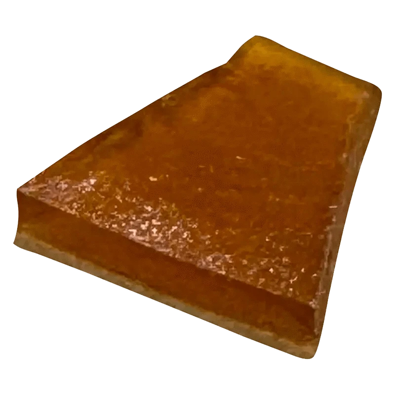 A close-up of the MAX Exhaust Haze Shatter, displaying a hazy, golden-brown material with a fractured, crystalline texture.