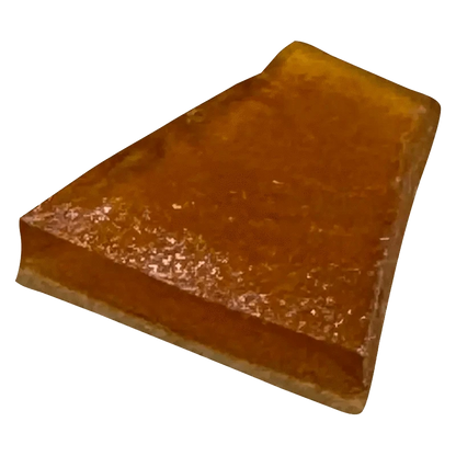 A close-up of the MAX Exhaust Haze Shatter, displaying a hazy, golden-brown material with a fractured, crystalline texture.