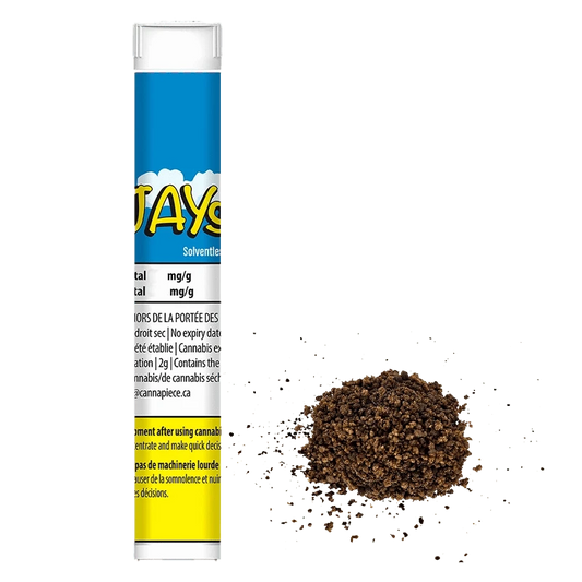 Tall front-facing tube labeled Dash Of Hash stands upright on the left with a small loose brown hash crumble pile to its right on a white background.
