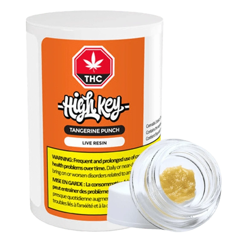 Close-up of the Tangerine Punch Live Resin container with a white label and black text, angled on a dark surface.