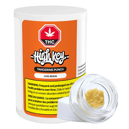 Close-up of the Tangerine Punch Live Resin container with a white label and black text, angled on a dark surface.