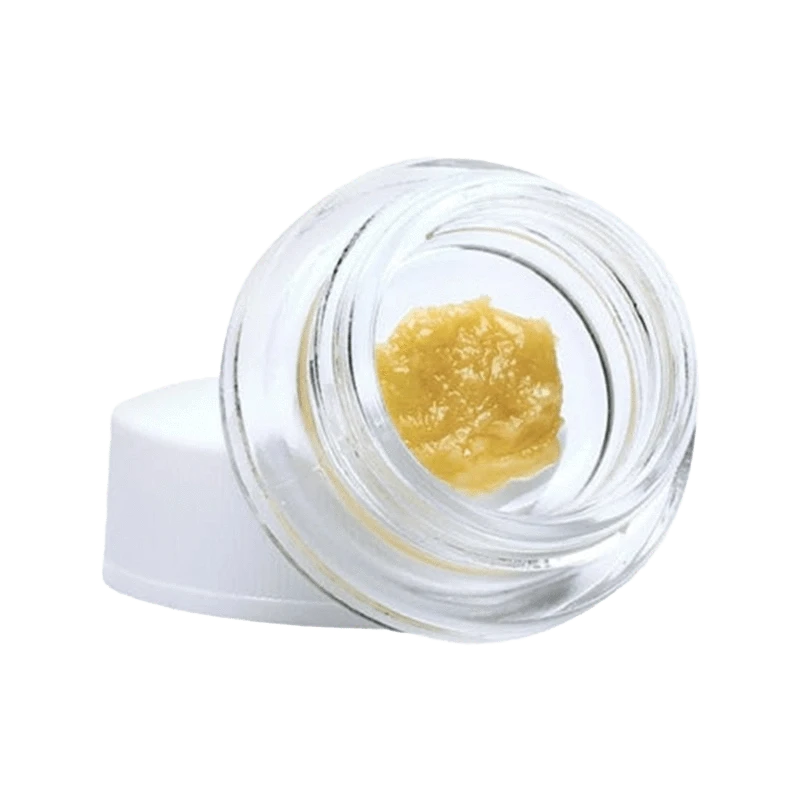 A close-up, top-down view of Tangerine Punch Live Resin, showcasing its golden, textured surface in a clear container.