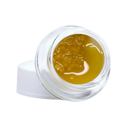 Close-up of the Gelato #33 Diamonds & Terp Sauce with a golden, viscous texture visible within a clear container.