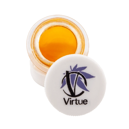 Close-up of Orange Bud Terp Sauce in a clear jar, displaying its golden hue and viscous texture.